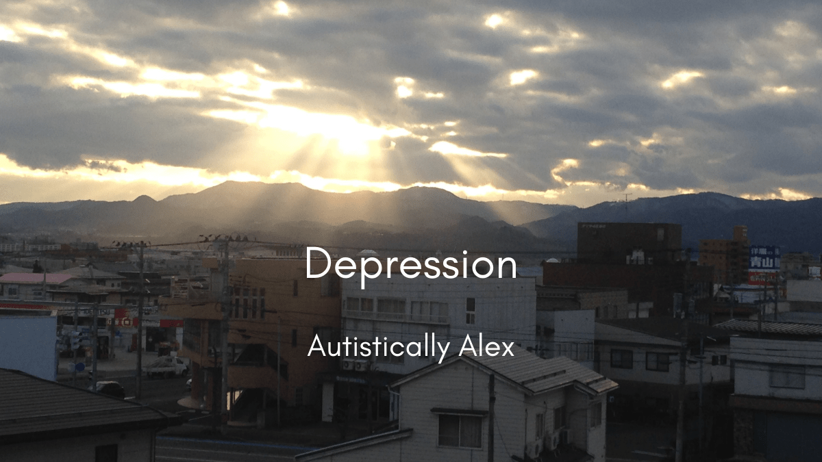 A dark, cloudy day in Japan. The photo overlooks a small city with many buildings. Off in the distance, rolling mountain ranges cover the horizon. Bright rays of sun are shining through the dark clouds. Text reads "Depression"